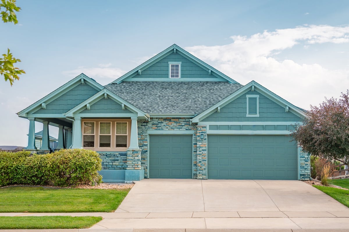Newly constructed modern blue wooden house in a suburban single-family residential area
