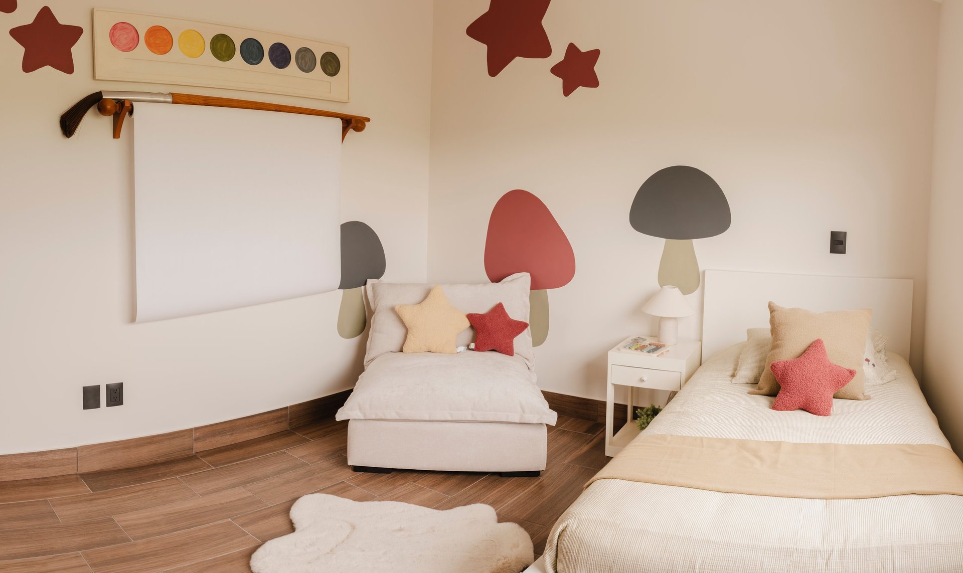 Modern childrens bedroom with two twin beds, whimsical mushroom and star wall decals, whiteboard, wooden flooring, and colorful decorative elements