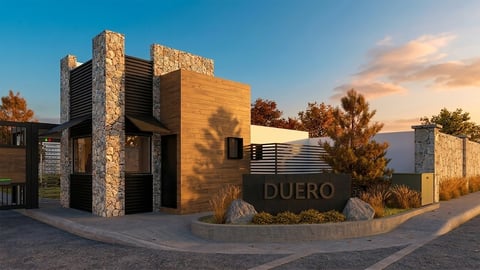 Modern building with stone and wood exterior at sunset in desert landscape with Duero signage