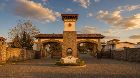 Stone building with tower entrance gate at sunset, featuring arched doorways and warm golden light