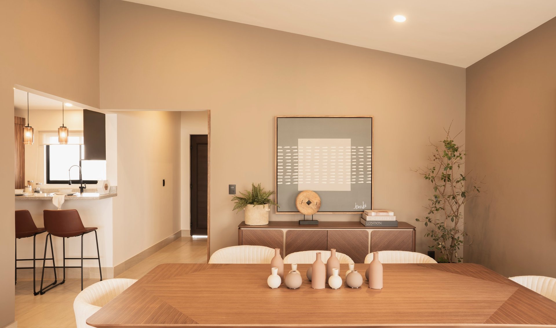 Modern minimalist home interior with wooden dining table, kitchenette, beige walls, and spa-like decor elements