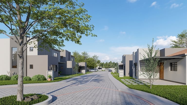 Residential street with modern townhouses and brick paved pathway lined with mature trees under blue sky